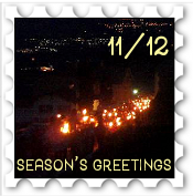 November/December 2019 Season's Greetings SWG Challenge stamp - photo showing a number of lamps illuminating a gathering in the foreground, with a night cityscape in the background