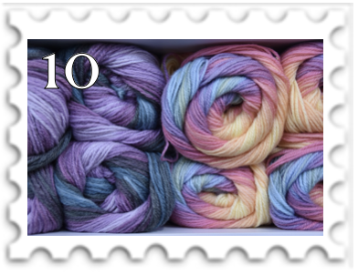 October 2023 Experimental SWG challenge stamp - photo of stacked variegated skeins of yarn