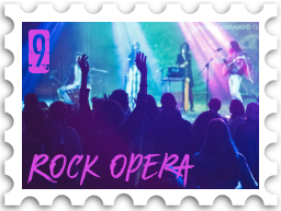 September 2023 Turgon's Rock Opera SWG challenge stamp - photo of a band on stage in front of a large audience; the photo is taken from the audience. One audience member has their hands raised. The band are lit from above by colorful lights.