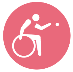 person in a wheelchair tossing a ball