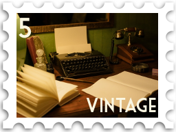 May 2022 Vintage SWG challenge stamp - an desk with open blank books, an old-fashioned typewriter with a fresh page in it ready to type, and an antique telephone in the background