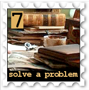July 2019 Solve A Problem SWG challenge stamp - Photo of a slightly messy desk stacked with books and papers, a coffe cup lurking in the middle