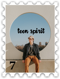 July 2018 Teen Spirit SWG challenge stamp - Photo of a young person wearing a ballcap sitting in front of a circular cutout in a wall showing a cityscape visible in the distance