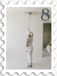 August 2022 Restoration and Rebuilding SWG challenge stamp - color photo of a person using a long-handled paint roller to put a base coat on the wall of a room undergoing renovation