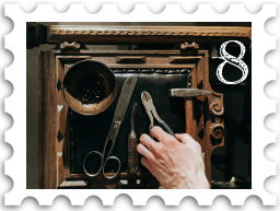 August 2022 Restoration and Rebuilding SWG challenge stamp - color photo of a hand reaching for a tool on a workbench