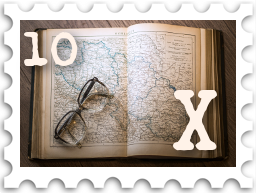 October 2022 X Marks the Spot SWG challenge stamp - color photo of a book opened to a map, with a pair of glasses set on the verso