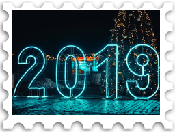January 2023 Jubilee SWG challenge stamp - postage stamp with a color photo of the number 2019 in blue neon lights against a dark background