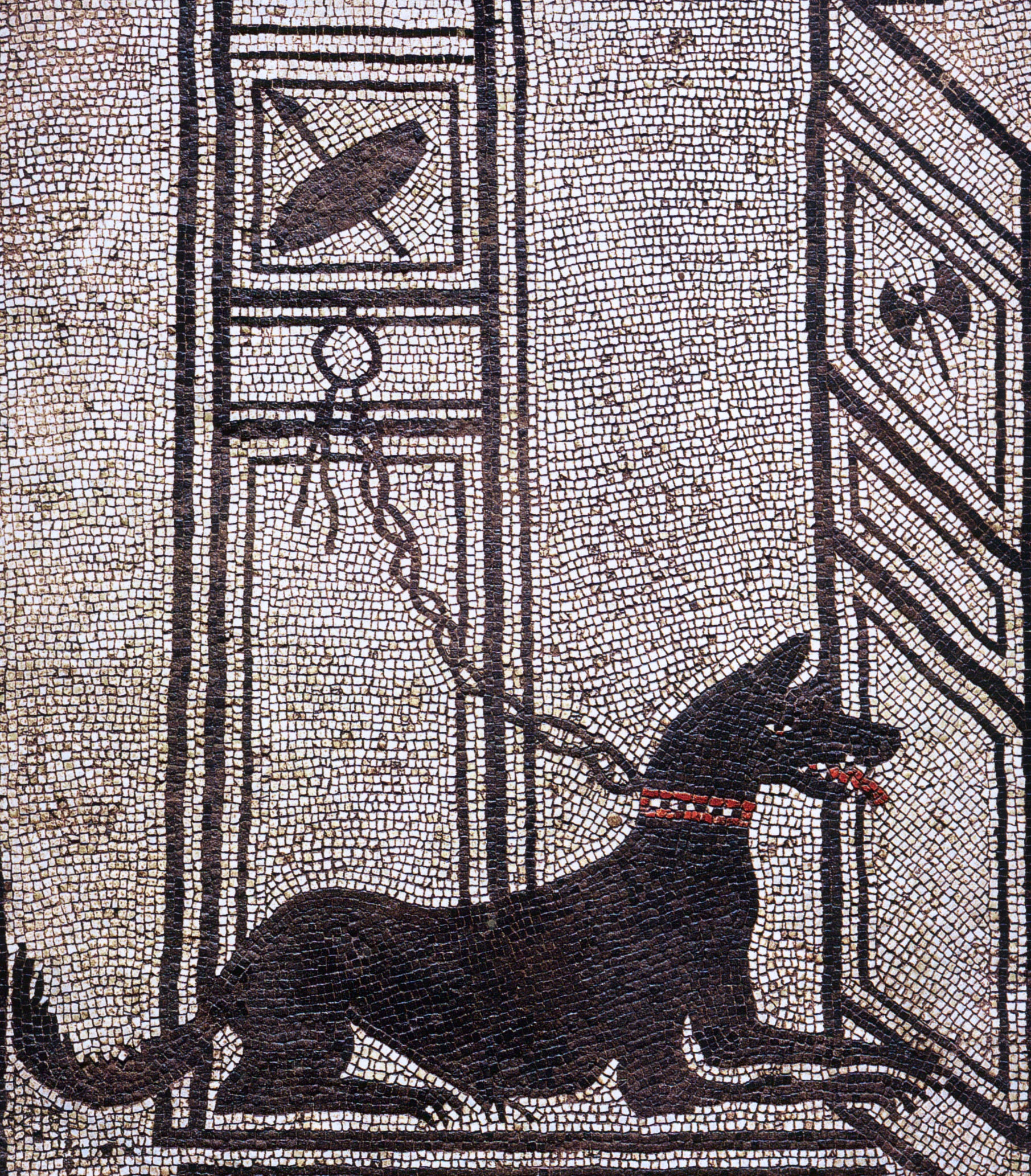 mosaic of black guard dog tethered to a wall