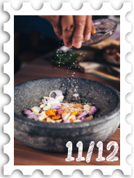November/December 2024Potluck SWG challenge stamp - a hand dropping salt or spices into a stone bowl containing a colorful mixture