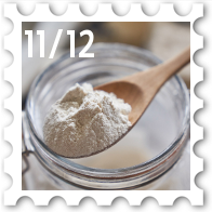 November/December 2025 Great Beleriand Bake-Off SWG challenge stamp - photo of a wooden spoon with flour above a glass jar containing sourdough starter