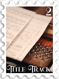 February 2026 Title Track SWG challenge  stamp - a photo of a manuscript musical score sitting on the strings of an open grand piano