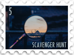 May 2026 Famous Last Words SWG challenge  stamp - a color photo of what may be a magnifying glass but may also be a telescope looking over a balcony. The backdrop is that of dusk or pre-dawn, with scenery only just visible. Centered in the lens is the Hagia Sofia against a sunrise/sunset sky, with birds flying. in the sky. Ciry lights are still visible both in front of and around the mosque. dark blue 