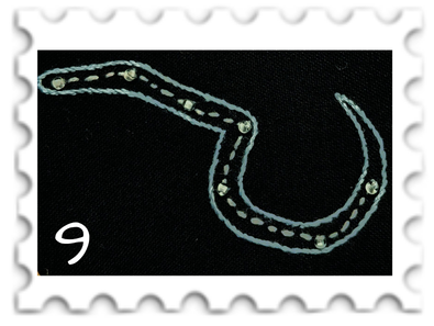 September 2026 Stars SWG challenge  stamp - embroidery of the constellation Valacirca against a black background; the stars are picked out in silver/gold, while the outline of the sickle is in blue.