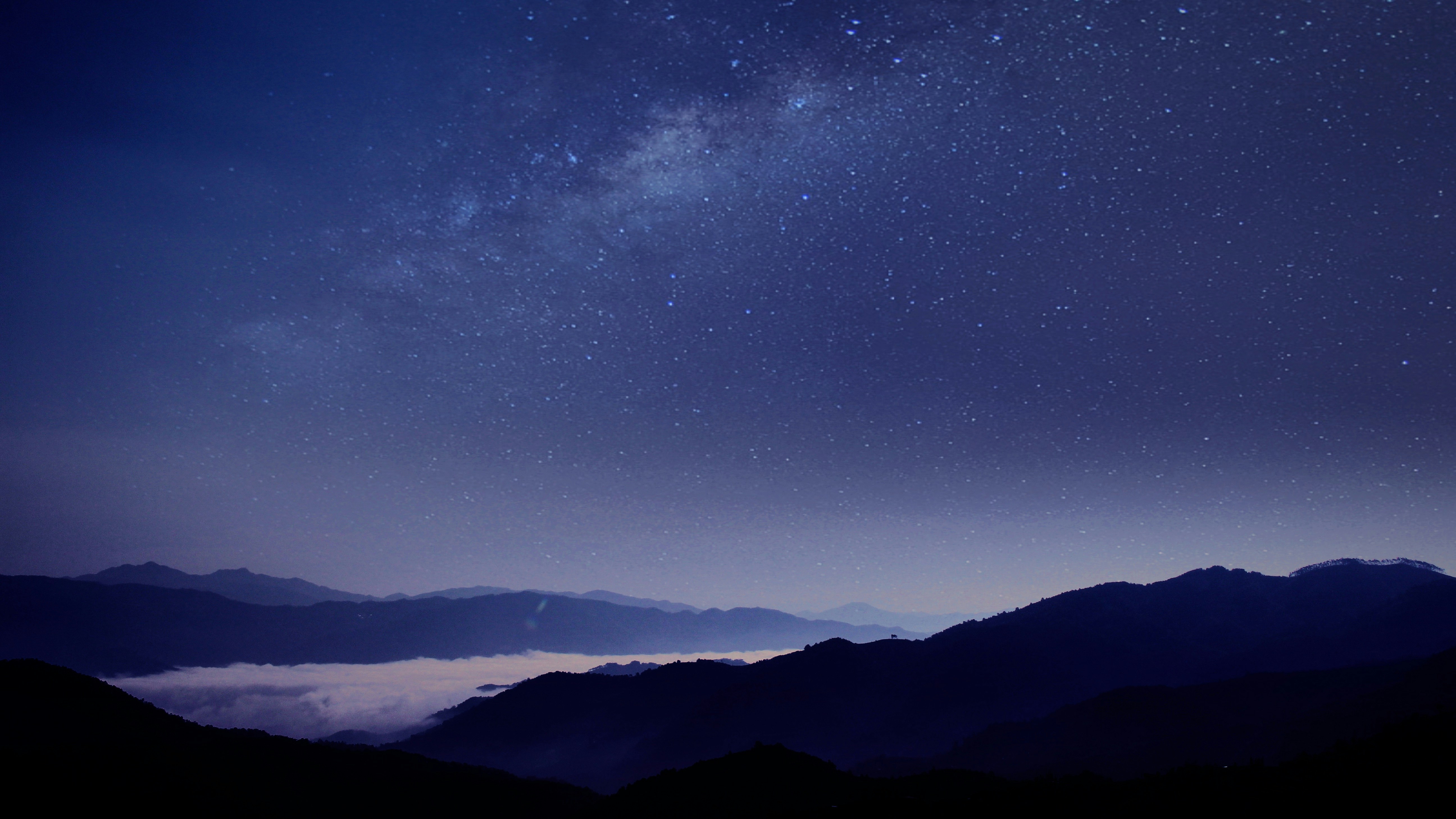 starry sky and milky way at night over mountains