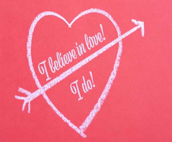 I believe in love! I do! inside a heart with arrow on pink background