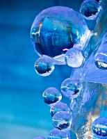 Round, blue droplets of water in a painting 