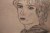 A pencil sketch prtrait of Frodo as he appears after emerging from Moria in Peter Jackson's Fellowship of the ring.  Frodo is turned toward the viewer with a distinctly unhappy expression on his face.