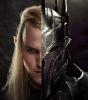 an image of a male elf with long blond hair whose face is half obscured by a suit of armor